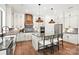 Modern kitchen with an island, stainless appliances, and custom range hood at 14210 Kershaw Cir # 20, Huntersville, NC 28078