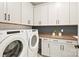 Well-equipped laundry room with white cabinets, counter space, and modern appliances at 14210 Kershaw Cir # 20, Huntersville, NC 28078