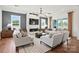 Inviting living room with modern lighting, fireplace, and plenty of natural light at 14210 Kershaw Cir # 20, Huntersville, NC 28078
