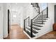 Modern staircase with black metal railings and hardwood steps, leading to the upper level of the home at 14210 Kershaw Cir # 20, Huntersville, NC 28078