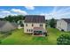An aerial view of the backyard featuring a patio with outdoor furniture and a well-maintained lawn at 14316 Baytown Ct, Charlotte, NC 28078