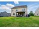A well manicured backyard with an outdoor patio and green lawn space at 14316 Baytown Ct, Charlotte, NC 28078