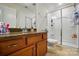 Bathroom with wood vanity, granite counters, framed glass shower and tile floors at 14316 Baytown Ct, Charlotte, NC 28078