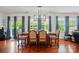 Elegant dining room with stylish lighting, hardwood floors, and large windows overlooking the yard at 14316 Baytown Ct, Charlotte, NC 28078