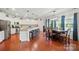 Modern eat-in kitchen with white cabinets, granite countertops, stainless steel appliances, and dining area at 14316 Baytown Ct, Charlotte, NC 28078