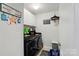 Laundry room with modern washer and dryer, ample storage space, and whimsical decor at 14316 Baytown Ct, Charlotte, NC 28078