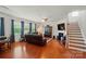 Spacious living room with hardwood floors, fireplace, and large windows allowing ample natural light at 14316 Baytown Ct, Charlotte, NC 28078