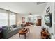 Spacious living room with a ceiling fan, large windows, and a work area at 14316 Baytown Ct, Charlotte, NC 28078