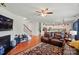 Open concept living room view to kitchen with hardwood floors, ceiling fan, and staircase at 14316 Baytown Ct, Charlotte, NC 28078