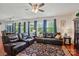 Living room featuring hardwood floors, multiple windows, and comfortable seating arrangement at 14316 Baytown Ct, Charlotte, NC 28078