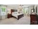 Bright main bedroom featuring a dark wood bed frame and matching furniture at 14316 Baytown Ct, Charlotte, NC 28078
