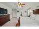 Main bedroom with white walls, a dresser, a ceiling fan, and access to a bathroom at 14316 Baytown Ct, Charlotte, NC 28078