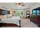 Bright main bedroom with a dark wood bed frame, dresser, and ceiling fan at 14316 Baytown Ct, Charlotte, NC 28078