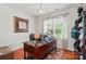Home office featuring hardwood floors, natural light, and a spacious desk area for productivity at 14316 Baytown Ct, Charlotte, NC 28078