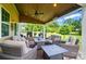 Back patio with outdoor seating and fire pit overlooking a beautiful yard with green trees at 14316 Baytown Ct, Charlotte, NC 28078