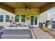 Covered patio featuring outdoor seating, a ceiling fan, and stone flooring at 14316 Baytown Ct, Charlotte, NC 28078