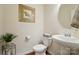 Cozy powder room with pedestal sink, decorative mirror, and modern fixtures at 14316 Baytown Ct, Charlotte, NC 28078