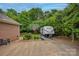 Backyard with brick home, basketball hoop, and RV parking at 144 Chickasaw Dr, Shelby, NC 28152