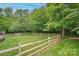 Spacious fenced backyard with green grass and a playground, perfect for outdoor activities and relaxation at 144 Chickasaw Dr, Shelby, NC 28152