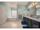 Bright bathroom featuring double vanity, a tub and tile flooring at 144 Chickasaw Dr, Shelby, NC 28152