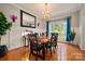Charming dining room features hardwood floors, large window, and classic chandelier at 144 Chickasaw Dr, Shelby, NC 28152