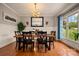 Dining room with an elegant table, chandelier, and large framed mirror reflecting natural light at 144 Chickasaw Dr, Shelby, NC 28152