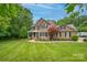 Well-manicured lawn and landscaping surround the beautiful two-story brick home at 144 Chickasaw Dr, Shelby, NC 28152
