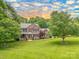 Charming two-story brick home boasts lush landscaping and a sprawling green lawn at 144 Chickasaw Dr, Shelby, NC 28152