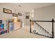 Upstairs hallway featuring neutral carpeting, black and white staircase, and decorative wall art at 144 Chickasaw Dr, Shelby, NC 28152