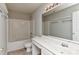 Standard bathroom featuring a shower-tub combo with white tiling and a sink with a large mirror at 14501 Asheton Creek Dr, Charlotte, NC 28273