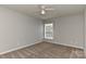 Neutral bedroom featuring carpet flooring, a ceiling fan, and a window for natural light at 14501 Asheton Creek Dr, Charlotte, NC 28273