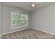 A neutral-toned bedroom features plush carpeting and a window with backyard view at 14501 Asheton Creek Dr, Charlotte, NC 28273