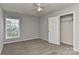 Bedroom with neutral walls, carpet flooring, ceiling fan, and window providing natural light at 14501 Asheton Creek Dr, Charlotte, NC 28273