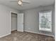 Standard bedroom with neutral walls, carpet flooring, closet, and window letting in natural light at 14501 Asheton Creek Dr, Charlotte, NC 28273