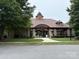 Stone and brick community entrance with manicured lawn, arched entryway and covered walkway for a welcoming feel at 14501 Asheton Creek Dr, Charlotte, NC 28273