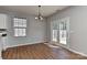 Bright dining area with wood floors, French doors to the backyard, and modern lighting at 14501 Asheton Creek Dr, Charlotte, NC 28273
