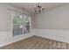 Cozy dining room with wainscoting, carpet flooring, and a decorative chandelier at 14501 Asheton Creek Dr, Charlotte, NC 28273