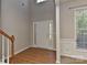 Bright foyer with hardwood floors, wainscoting, and a staircase, creating a welcoming entrance at 14501 Asheton Creek Dr, Charlotte, NC 28273