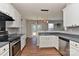 Bright kitchen with stainless steel appliances, white cabinets, and an eat-in area overlooking the backyard at 14501 Asheton Creek Dr, Charlotte, NC 28273