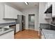 Modern kitchen featuring stainless steel appliances, white cabinets, and hard wood floors at 14501 Asheton Creek Dr, Charlotte, NC 28273
