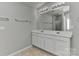 Main bathroom features a double vanity, and an oversized mirror reflecting natural light from the glass shower at 14501 Asheton Creek Dr, Charlotte, NC 28273