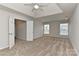 A spacious main bedroom featuring tray ceilings, a ceiling fan, and two large windows at 14501 Asheton Creek Dr, Charlotte, NC 28273