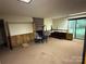 Spacious basement with a brick fireplace, offering potential for customization and entertainment at 1451 Blueberry Ln, Charlotte, NC 28226
