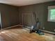 An empty room that has hardwood floors and a large window to let in natural sunlight and fresh air at 1451 Blueberry Ln, Charlotte, NC 28226