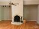 Spacious living room with beautiful floors and a brick fireplace at 1451 Blueberry Ln, Charlotte, NC 28226