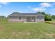 Back of house showing neutral siding, covered patio with white columns, and a well-maintained lawn at 154 Stable Brook Ln, Taylorsville, NC 28681