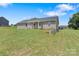 View of house from yard featuring a covered patio, grass, and trees at 154 Stable Brook Ln, Taylorsville, NC 28681