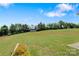 Large backyard with outbuilding, landscaping, treeline, and blue skies at 154 Stable Brook Ln, Taylorsville, NC 28681