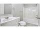Well-lit bathroom featuring a shower-tub combo, a single sink vanity, and neutral wall paint at 154 Stable Brook Ln, Taylorsville, NC 28681