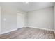 Bedroom featuring neutral walls, wood-look flooring, white trim and a double door closet at 154 Stable Brook Ln, Taylorsville, NC 28681